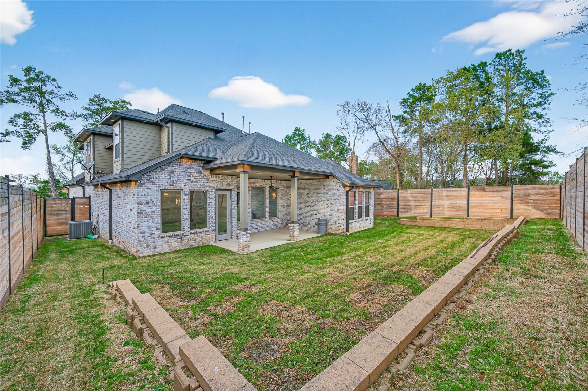 12379 Pebble View Drive Conroe, TX 77304 - Photo 43 of 49 a front view of a house with garden
