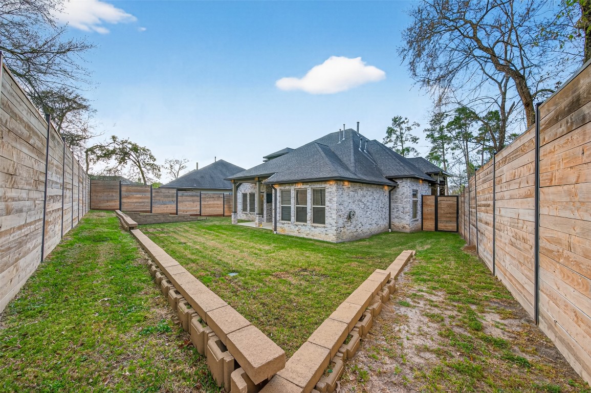 12379 Pebble View Drive Conroe, TX 77304 - Photo 46 of 49 a view of a house with a backyard
