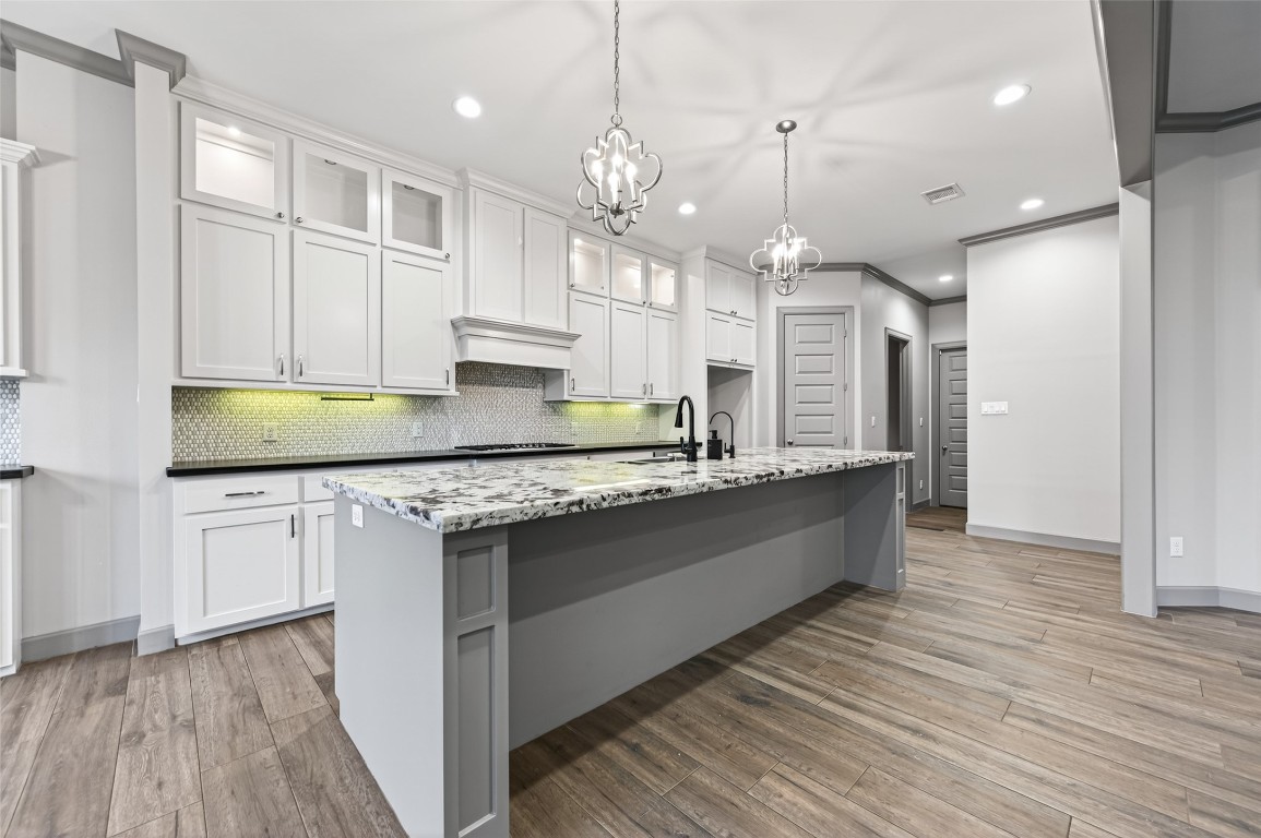 12379 Pebble View Drive Conroe, TX 77304 - Photo 9 of 49 a large kitchen with stainless steel appliances granite countertop a sink a stove and a wooden floors