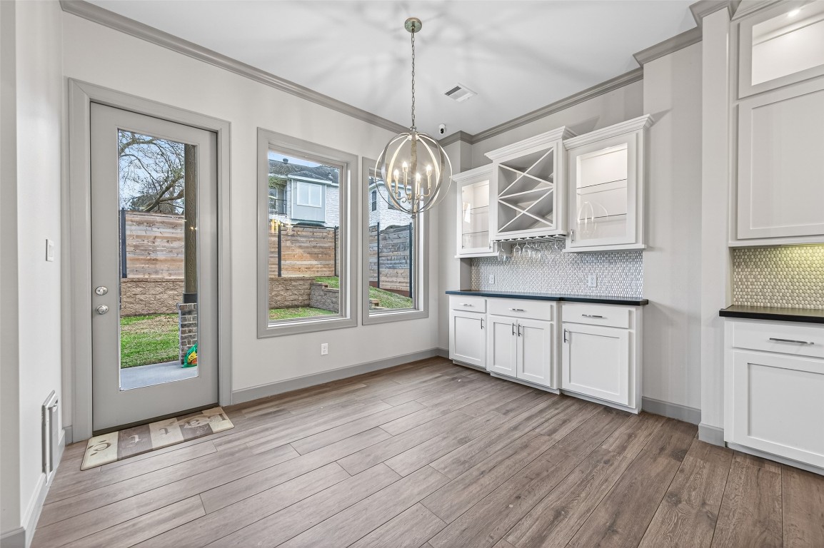 12379 Pebble View Drive Conroe, TX 77304 - Photo 10 of 49 a kitchen with stainless steel appliances granite countertop wooden floors and white cabinets