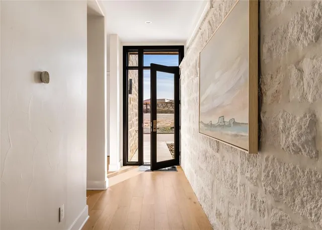 a view of a hallway with wooden floor and entryway