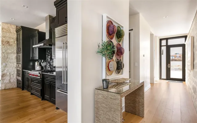 a large kitchen with kitchen island a counter top space a sink appliances and cabinets