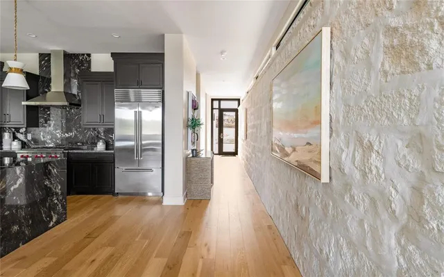 a kitchen with granite countertop a stove and a refrigerator