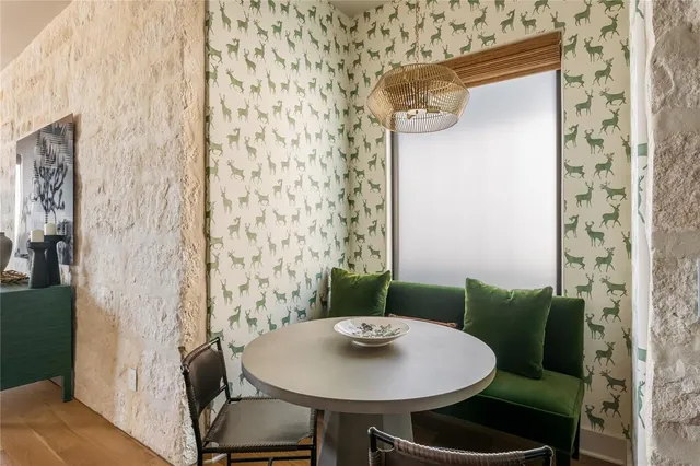 a dining room with furniture and a flat screen tv