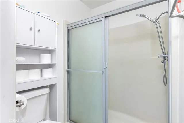a bathroom with a glass shower door