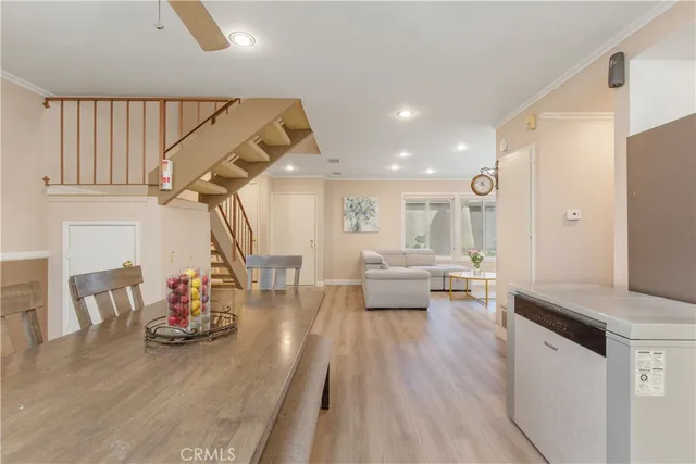 a living room with dining room and wooden floor