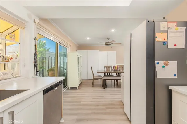 a kitchen with a table chairs refrigerator and cabinets