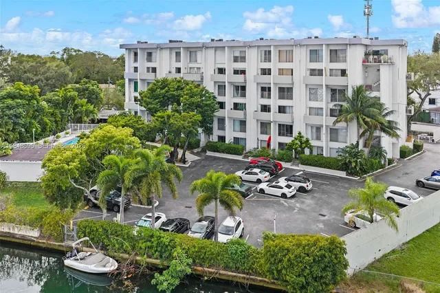 a view of a patio with plants and chairs and potted plants