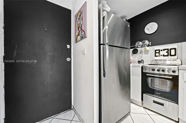 a view of a refrigerator and a stove top oven