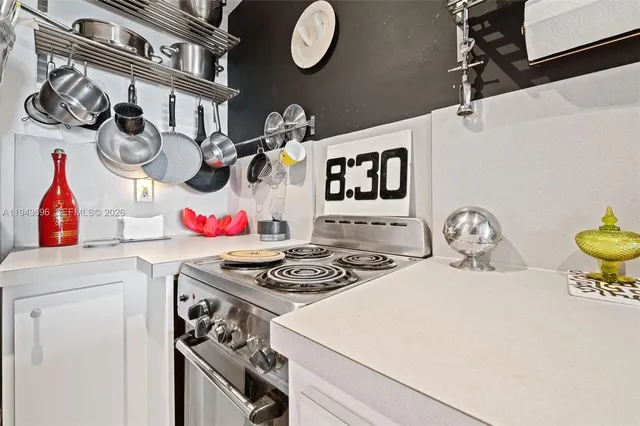 a kitchen with a white stove top oven and sink