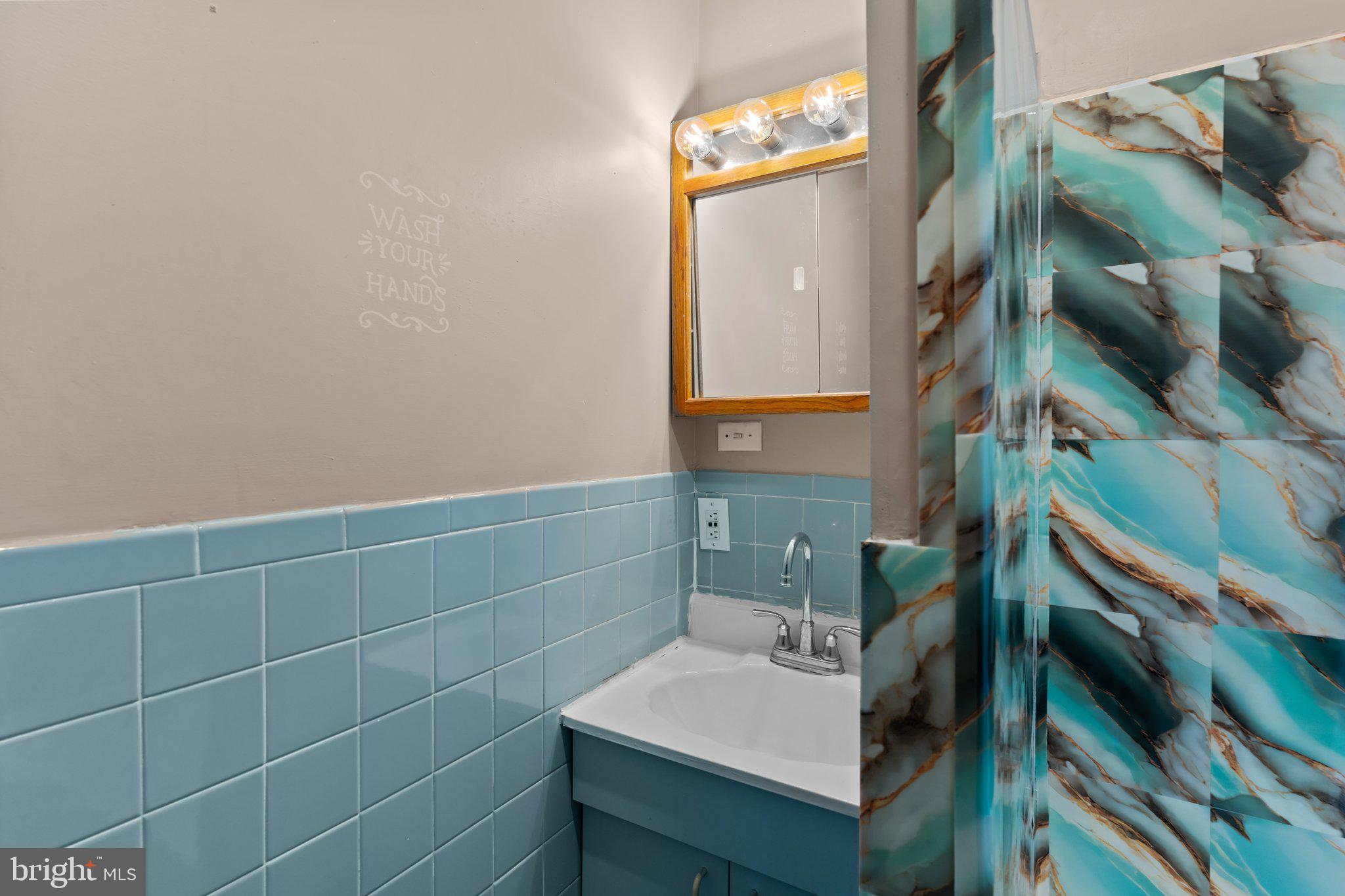 129 Blake Avenue Rockledge, PA 19046 - Photo 17 of 19 a bathroom with a sink and mirror