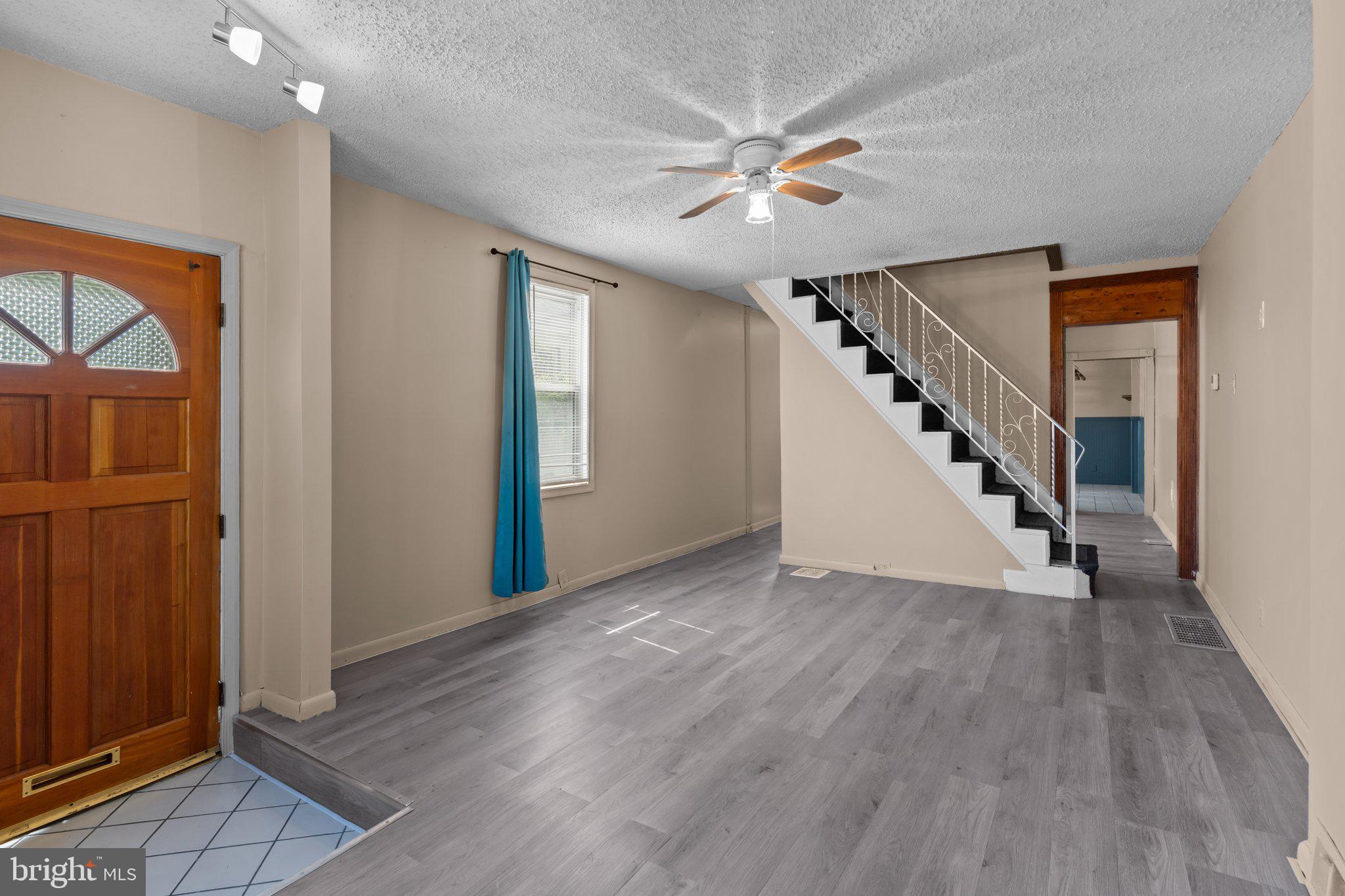 129 Blake Avenue Rockledge, PA 19046 - Photo 4 of 19 a view of an empty room with wooden floor and staircase