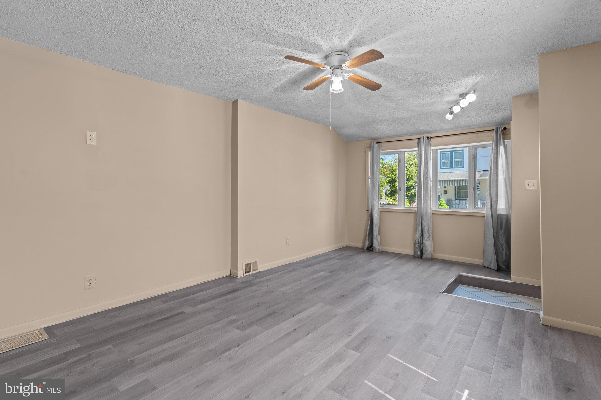 129 Blake Avenue Rockledge, PA 19046 - Photo 5 of 19 an empty room with wooden floor and windows