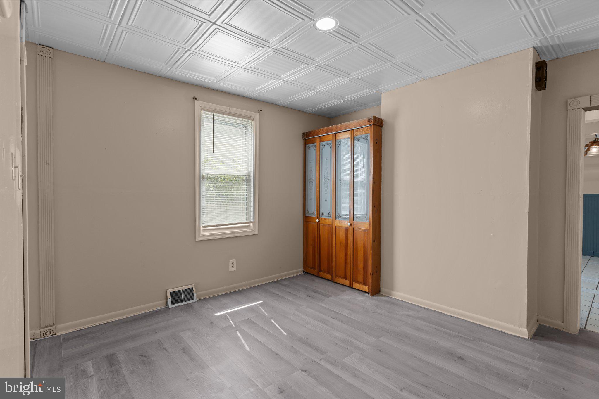 129 Blake Avenue Rockledge, PA 19046 - Photo 7 of 19 an empty room with wooden floor and windows
