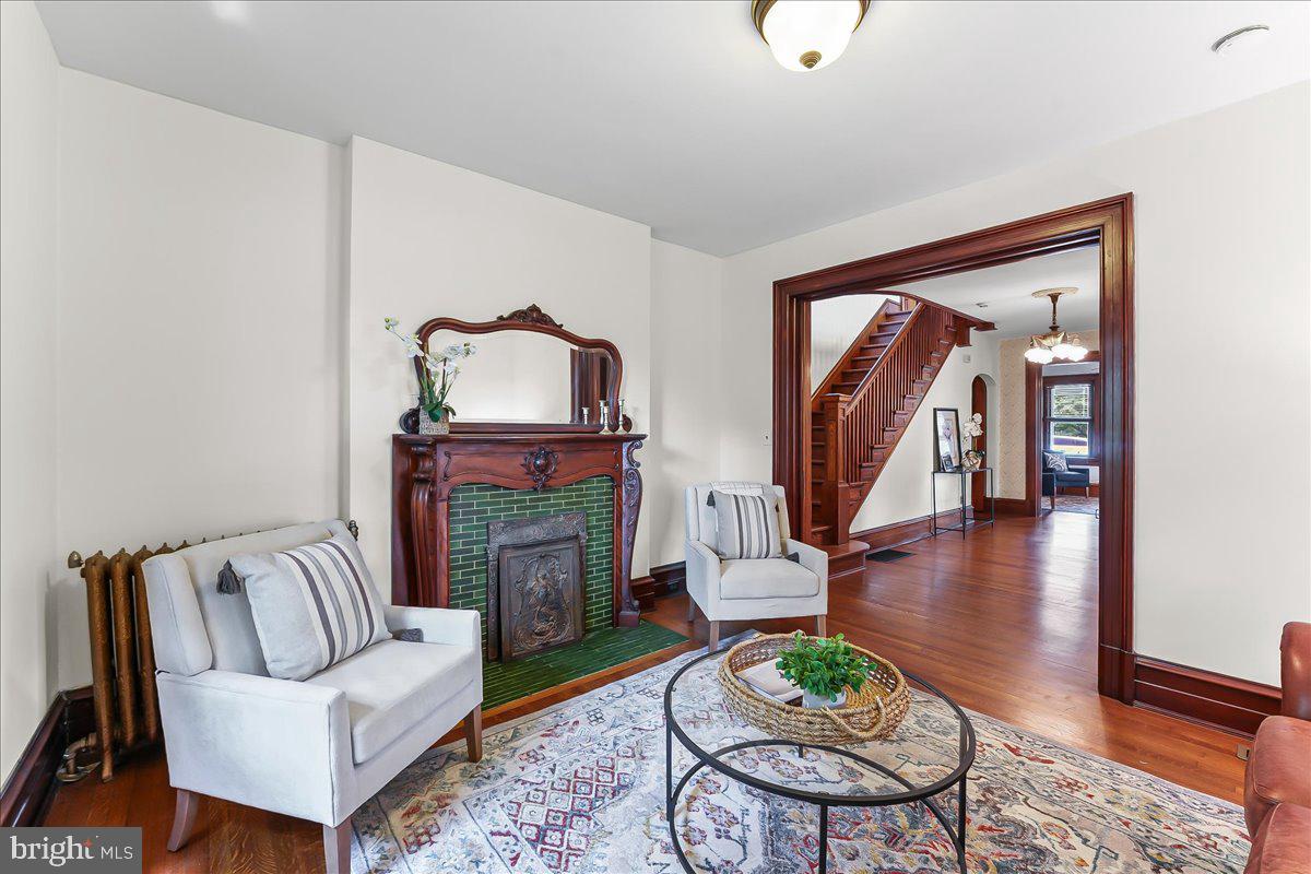 503 West State Street Kennett Square, PA 19348 - Photo 11 of 76 a living room with furniture a fireplace and a large mirror