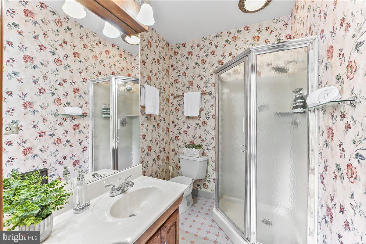 503 West State Street Kennett Square, PA 19348 - Photo 30 of 76 a bathroom with a sink mirror and shower