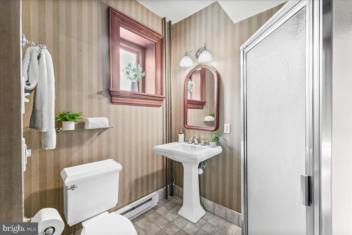 503 West State Street Kennett Square, PA 19348 - Photo 40 of 76 a bathroom with a sink a toilet and a mirror