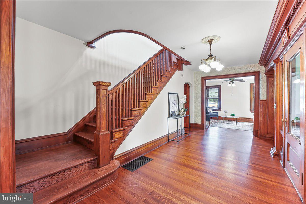 503 West State Street Kennett Square, PA 19348 - Photo 8 of 76 a view of staircase with wooden floor and a chandelier