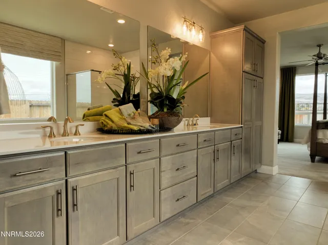 a bathroom with a double vanity sink mirror and shower