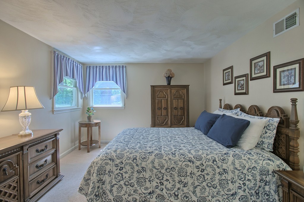 130 Ferncroft Road Tewksbury, MA 01876 - Photo 14 of 29 a bedroom with a large bed and a dresser