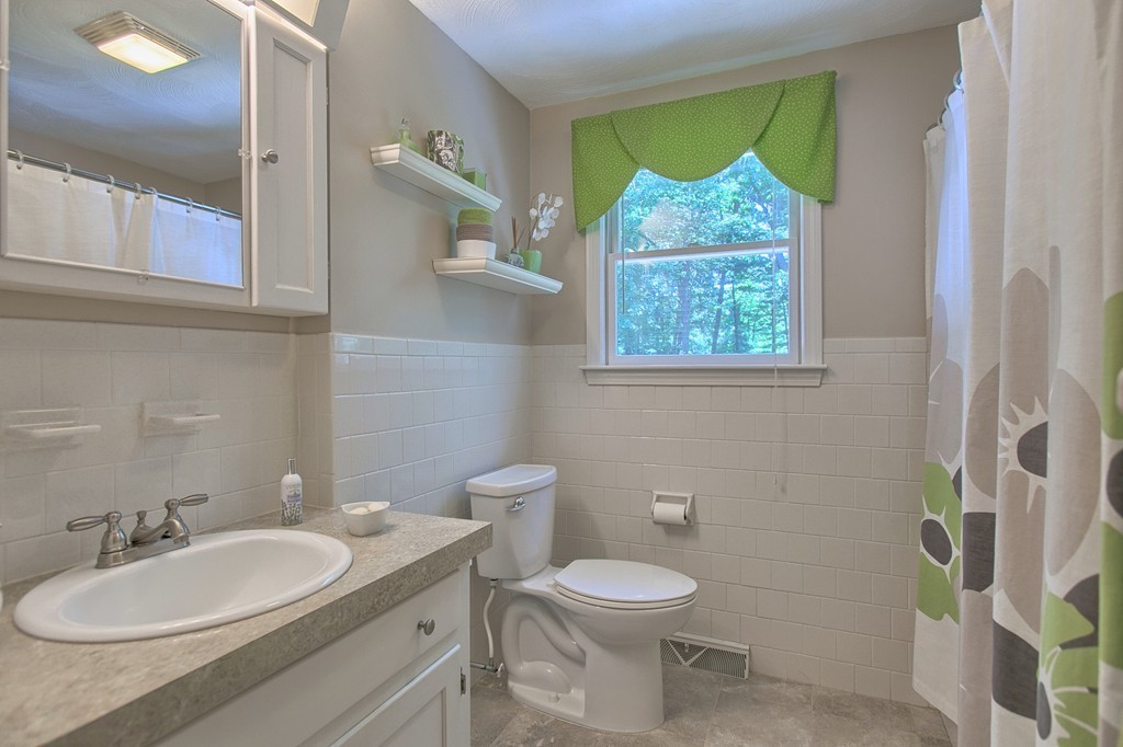 130 Ferncroft Road Tewksbury, MA 01876 - Photo 18 of 29 a bathroom with a toilet sink and mirror