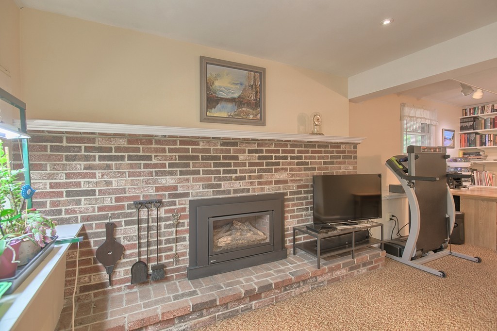 130 Ferncroft Road Tewksbury, MA 01876 - Photo 19 of 29 a living room with furniture a rug and a fireplace