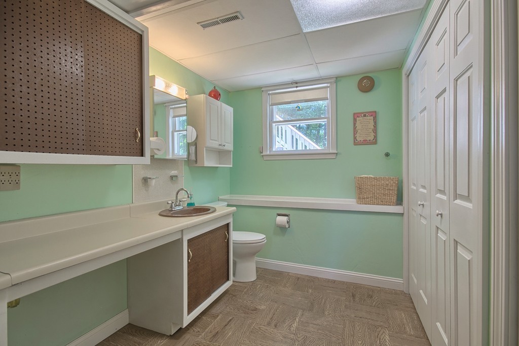 130 Ferncroft Road Tewksbury, MA 01876 - Photo 23 of 29 a bathroom with a sink a toilet and a mirror