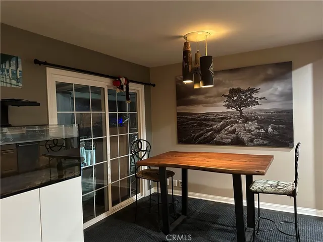 a room with table chairs and entryway