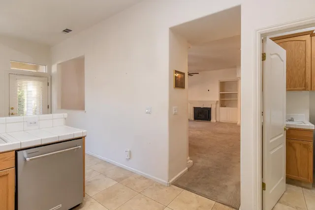 a bathroom with a granite countertop sink a mirror and a shower
