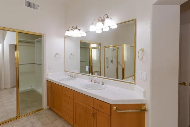 a bathroom with a double vanity sink and a mirror