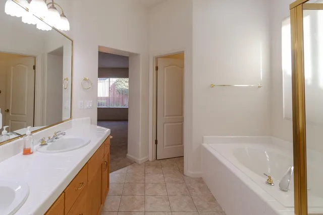 a bathroom with a tub sink and mirror