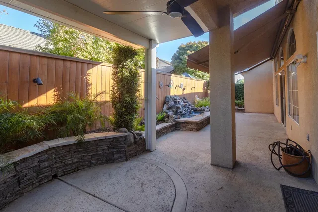 a view of a porch with furniture and garden