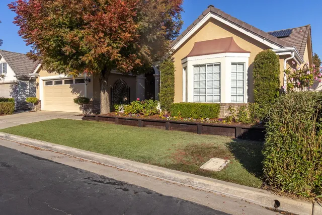 a front view of a house with garden