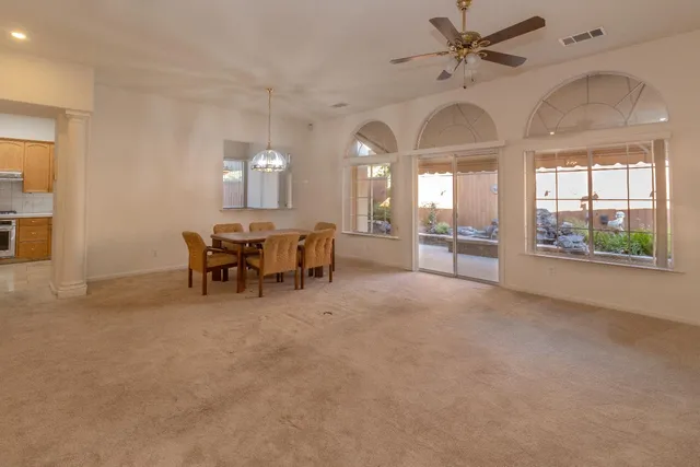 a view of a livingroom with furniture and chandelier fan
