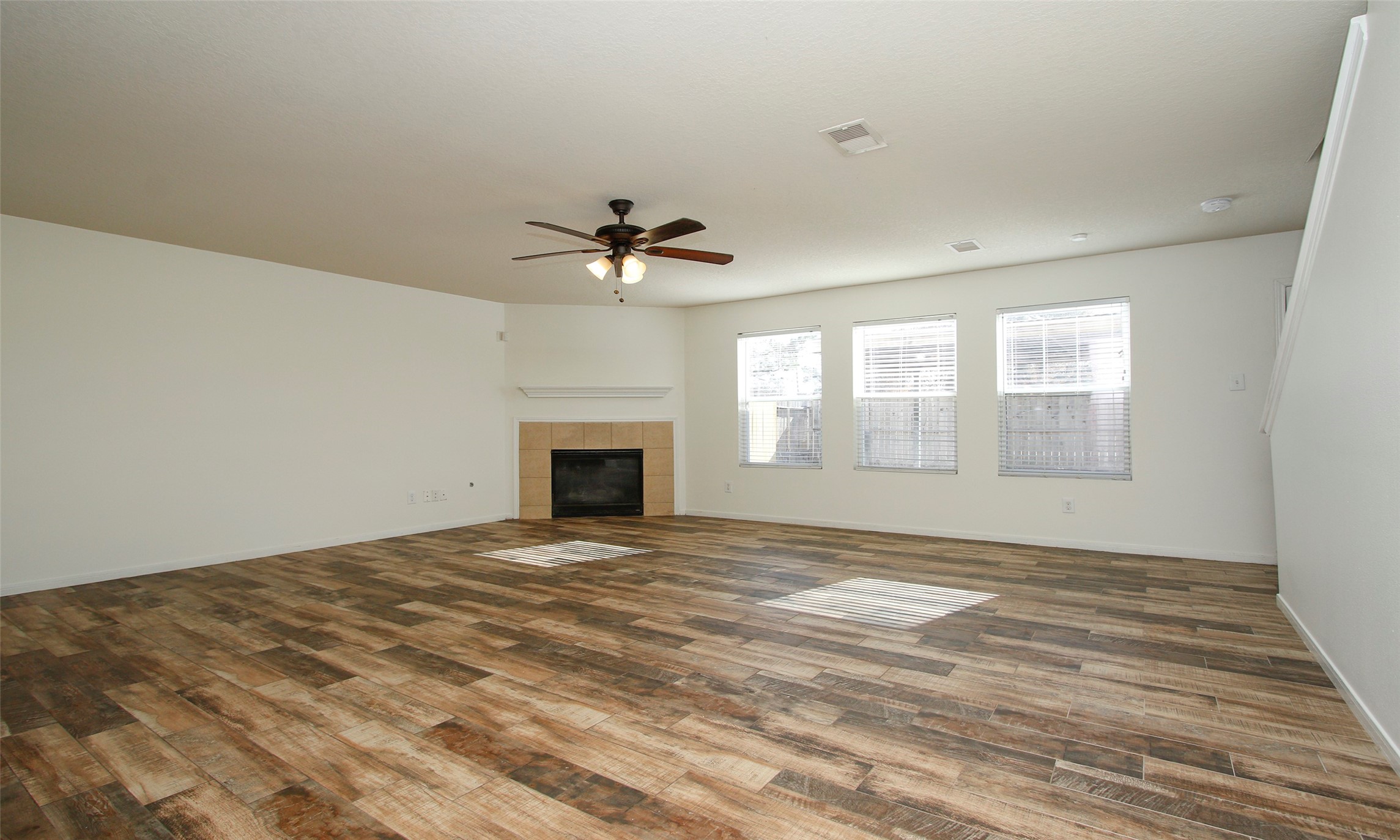 9812 Expedition Trail Conroe, TX 77385 - Photo 11 of 37 a view of an empty room with a fireplace and a window