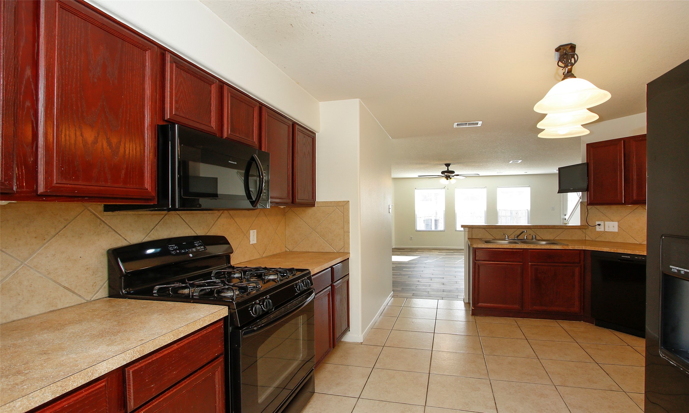 9812 Expedition Trail Conroe, TX 77385 - Photo 16 of 37 a kitchen with stainless steel appliances granite countertop a stove a sink and a microwave