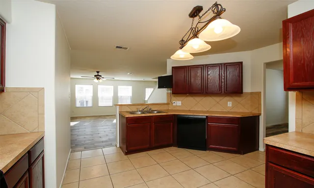 a kitchen with granite countertop a sink and a stove