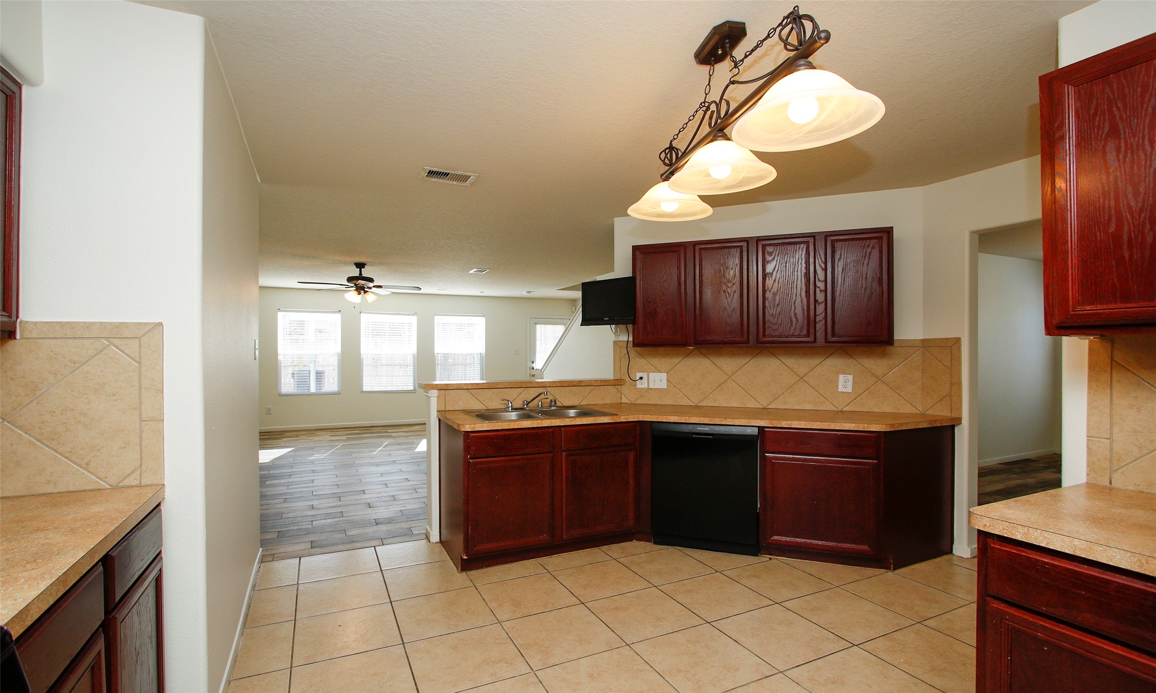 9812 Expedition Trail Conroe, TX 77385 - Photo 17 of 37 a kitchen with granite countertop a sink and a stove