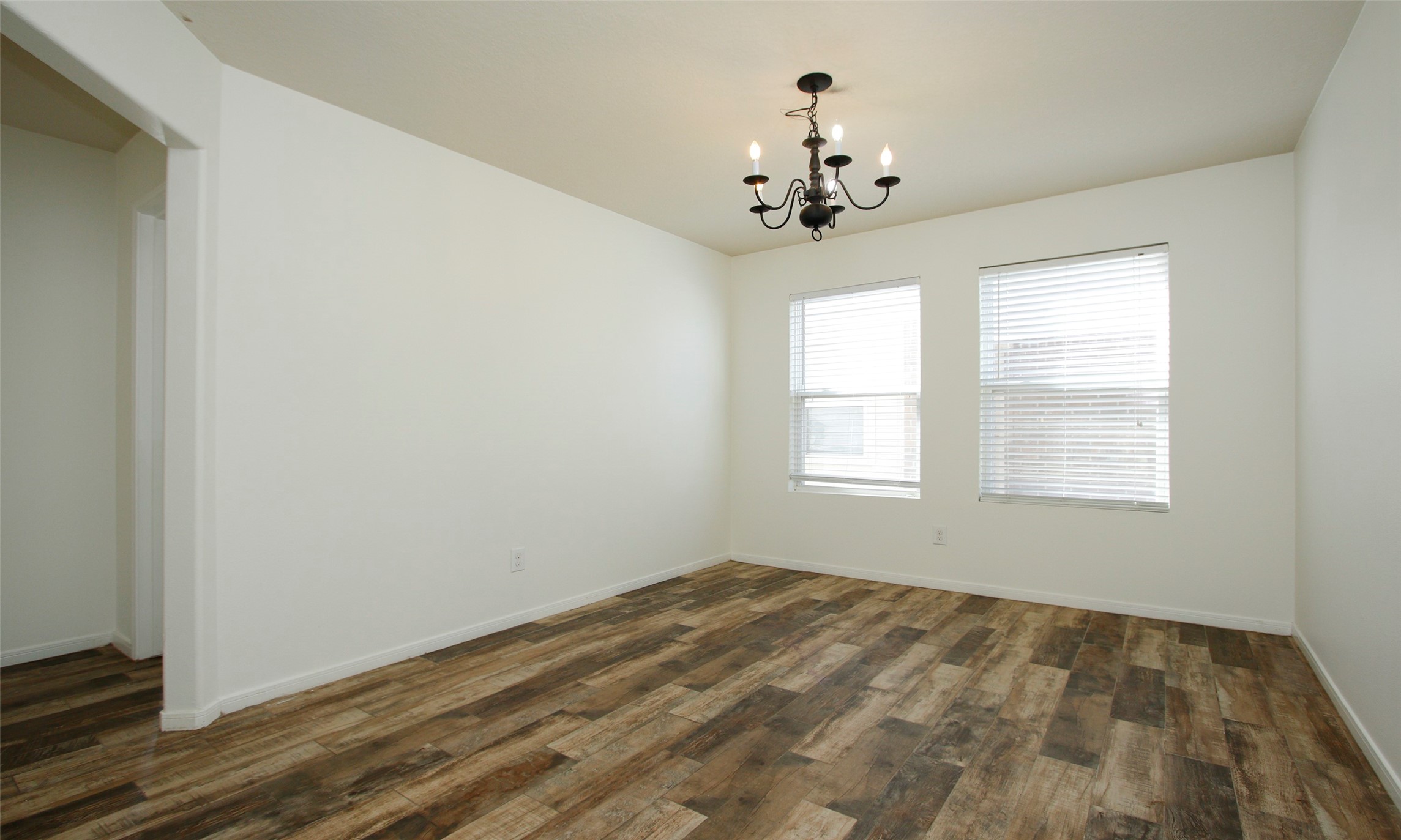 9812 Expedition Trail Conroe, TX 77385 - Photo 19 of 37 a view of a room with a chandelier fan and windows