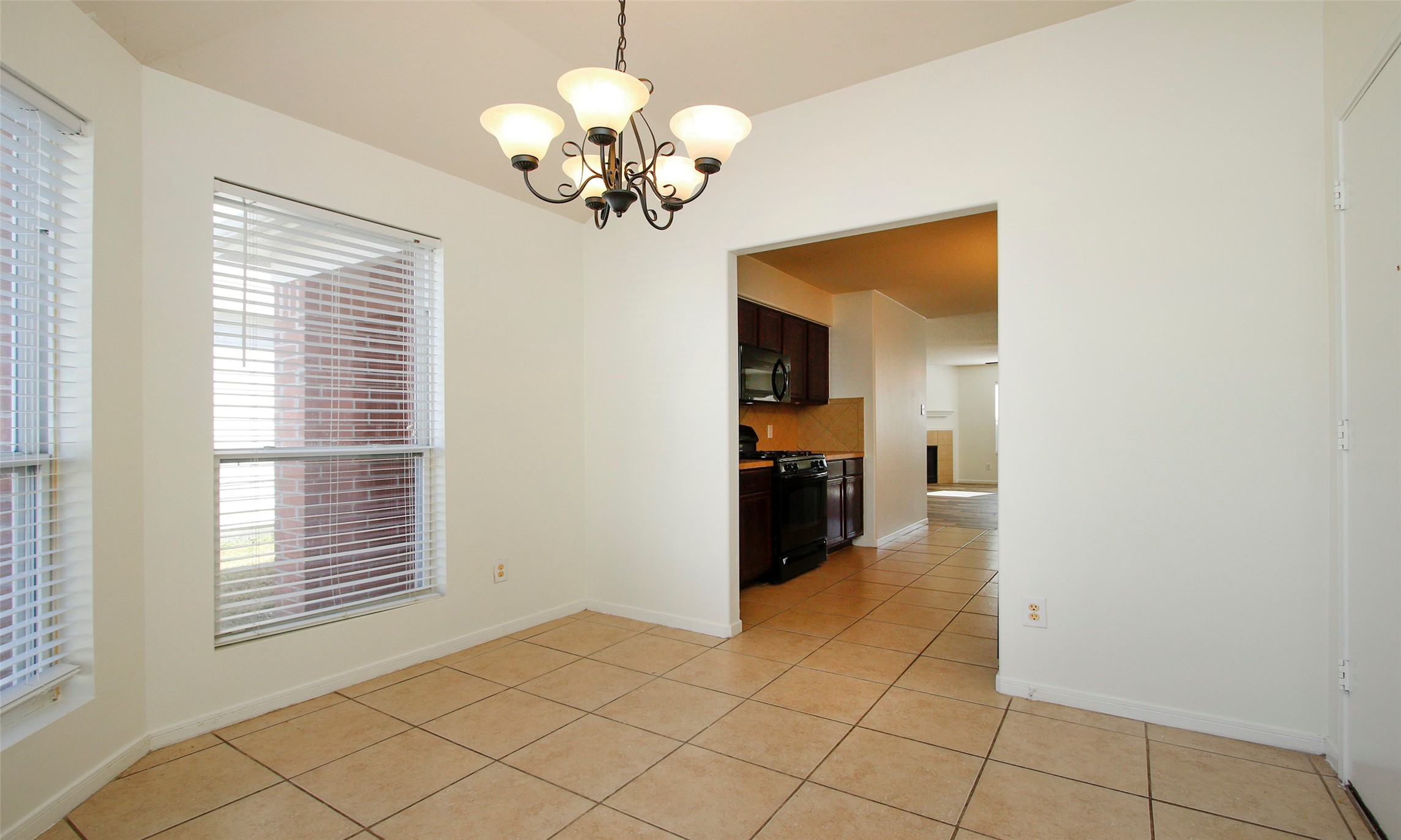 9812 Expedition Trail Conroe, TX 77385 - Photo 21 of 37 a view of a livingroom with a chandelier furniture and windows