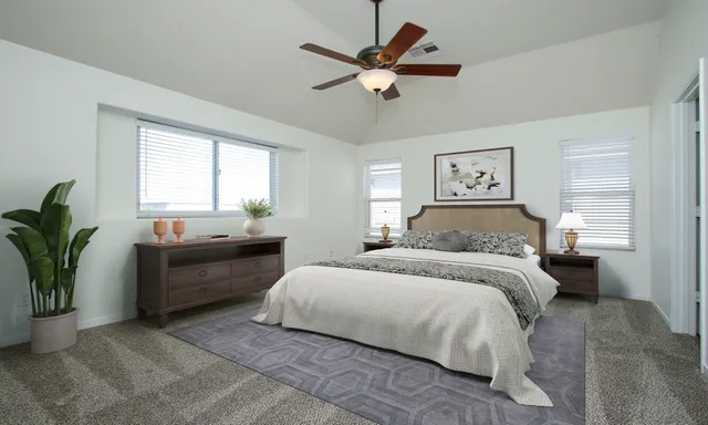 a bedroom with a large bed and a window