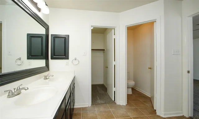 a spacious bathroom with a sink and a mirror