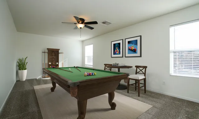 a room with pool table and windows