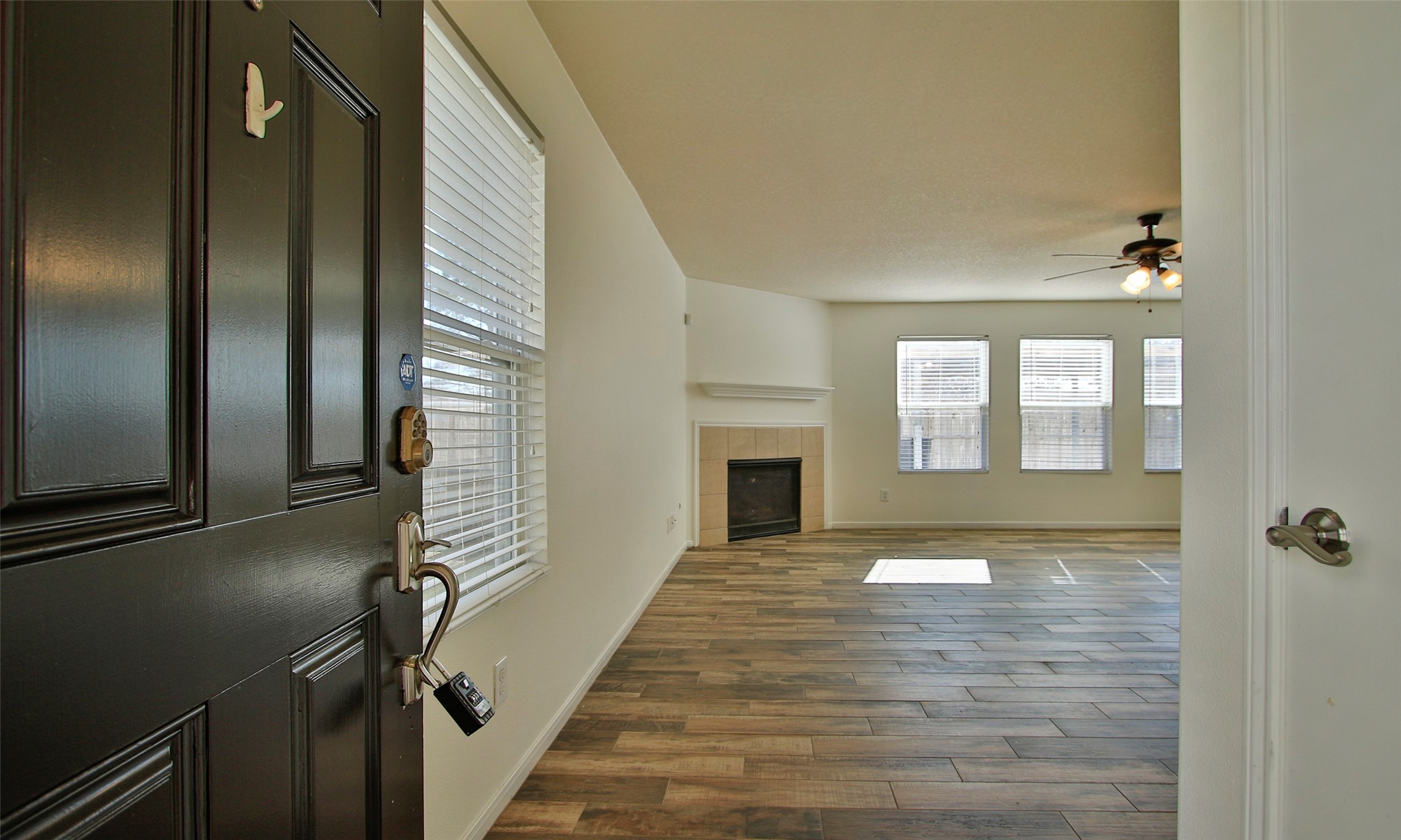 9812 Expedition Trail Conroe, TX 77385 - Photo 4 of 37 a view of an empty room with wooden floor and a window