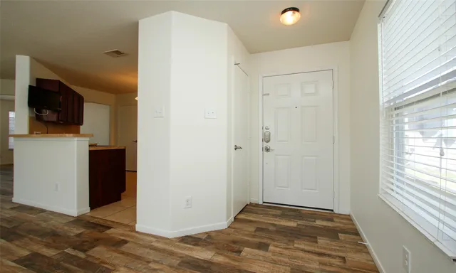a view of a livingroom with an empty space and a window