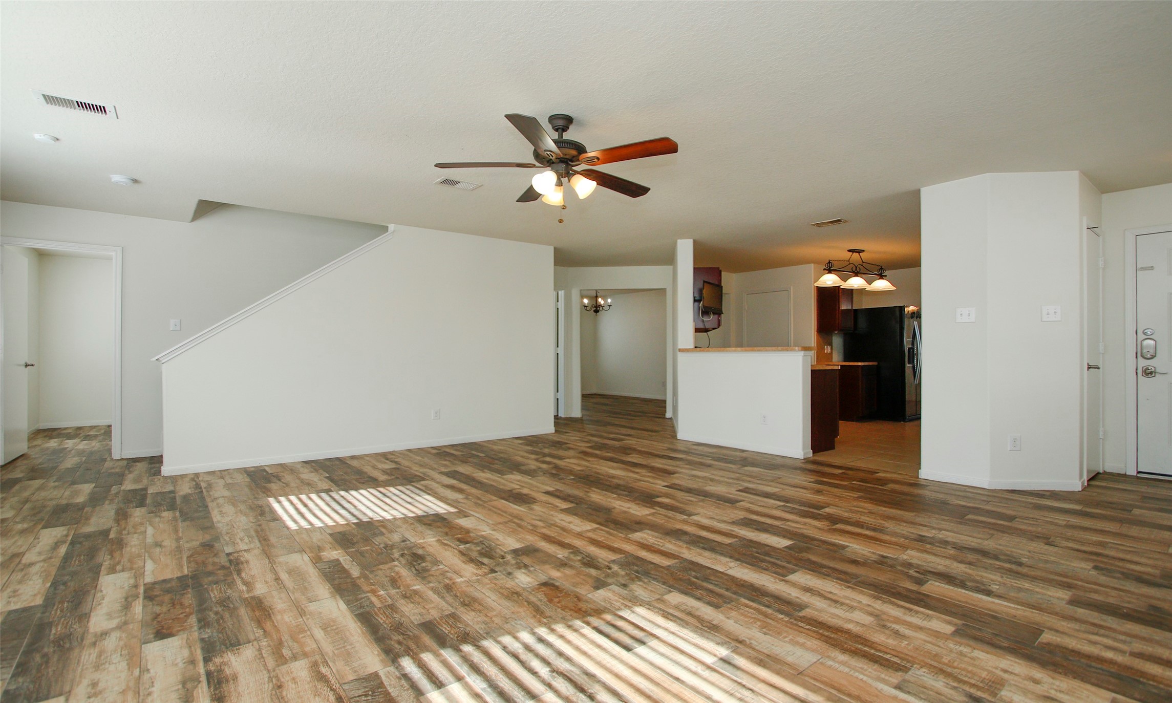 9812 Expedition Trail Conroe, TX 77385 - Photo 7 of 37 a view of a kitchen with a sink and a refrigerator