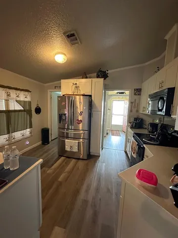 a kitchen with sink cabinets and wooden floor