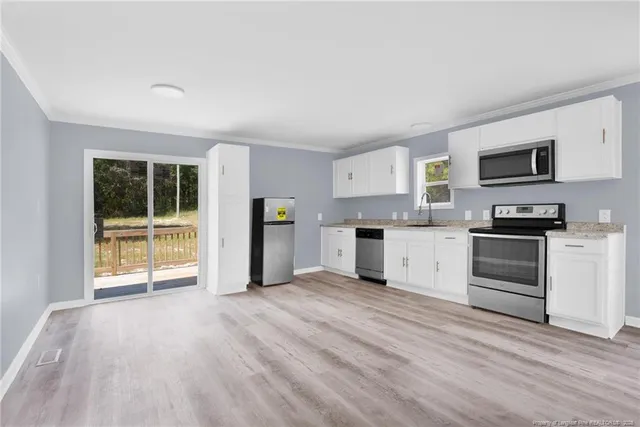 a view of kitchen with microwave and cabinets