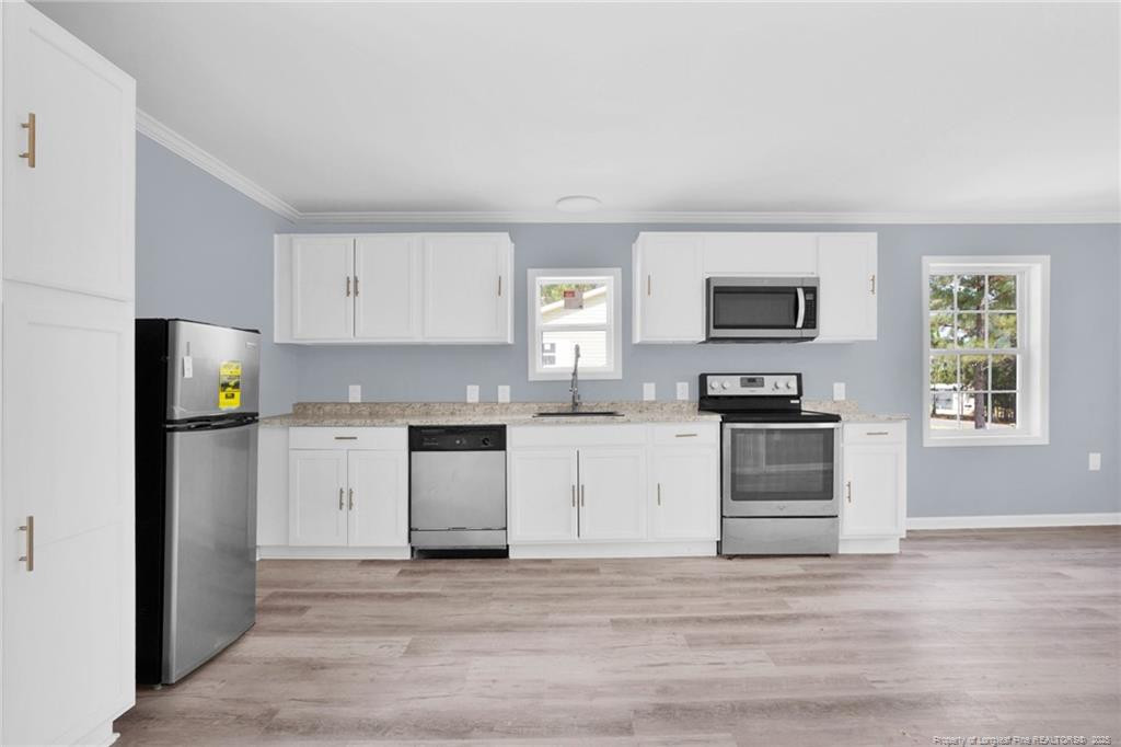 266 Brower Road Cameron, NC 28326 - Photo 12 of 26 a kitchen with granite countertop a refrigerator stove and microwave
