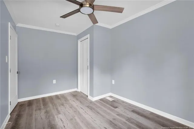 a view of empty room with wooden floor